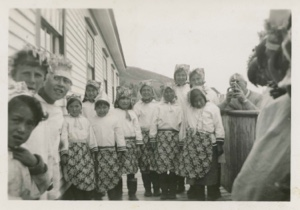 Image of Eskimo [Inuit] children at MacMillan Moravian Mission School. Dr. Hettasch taking movie